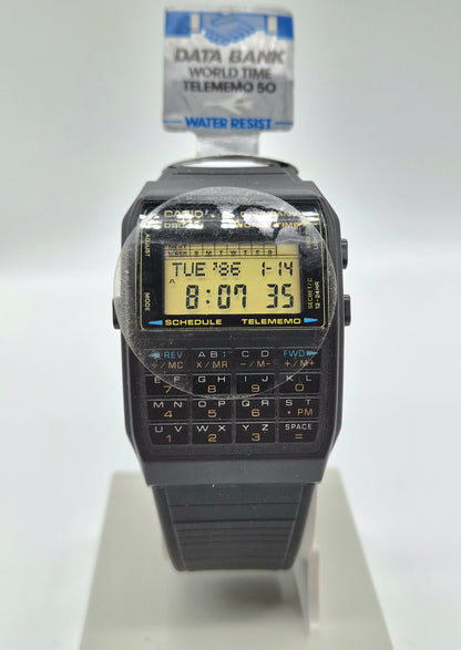 Front view of vintage Casio Data Bank World Time Telememo 50 calculator watch with black resin strap