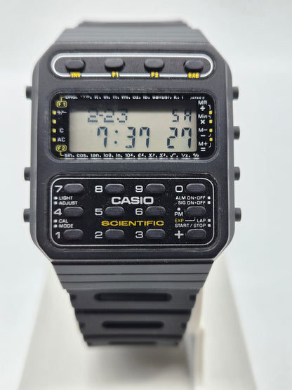 A Casio Scientific digital watch with a black plastic body and strap, featuring a large LCD display and a built-in numeric keypad on the front.