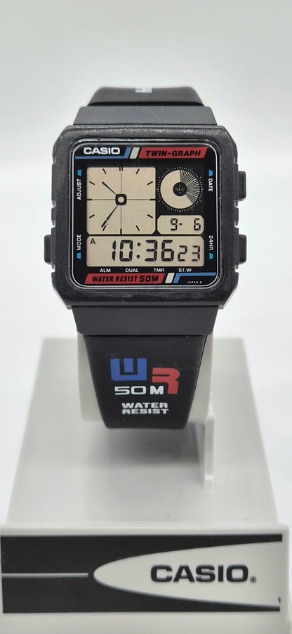 A Casio dual-graph analog-digital wristwatch with a black case and strap, displayed on a white stand against a light gray background.